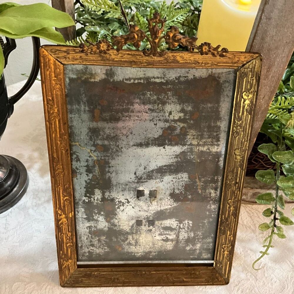 Antique gold gilded brass picture frame with ornate crest and glass easel back